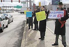 “They’re treating us like a bunch of criminals,” John Ritchie said (second from right). “Why do they need to have two security jeeps to watch us? Urban Outfitters must be upset with the negative publicity.”