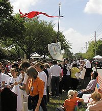 The banner of Cubanos Desterrados waves beside the high flying signature red banner of the American TFP.