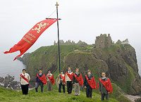 Students from St. Louis de Montfort Acadmeny pose for a picture in front of Dunnottar Castle, on the east coast of Scotland.