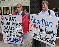 Peter Shibler and Matthew Taylor held thought-provoking signs on College Ave.