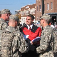 TFP member Cesar Franco distributes the full-page advertisement to soldiers.