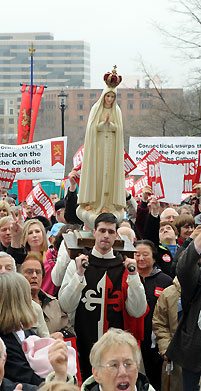 Members of the American TFP wearing the ceremonial habit carry Our Lady of Fatima.