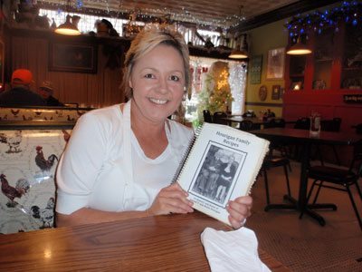 Christy Clark proudly holding the Hourigan Family Recipe Book which she inherited from her grandmother