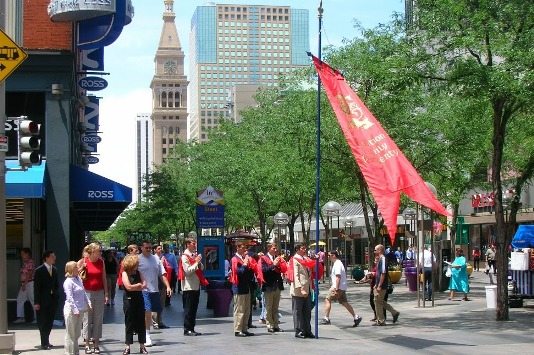 TFP members pray before a street campaign at a public intersection.