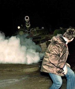 A Lithuanian flees a Soviet tank during the Russian invasion of Lithuania and occupation of Vilnius’ radio and TV station, January 13, 1991