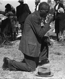 Claude Newman kneeling and praying