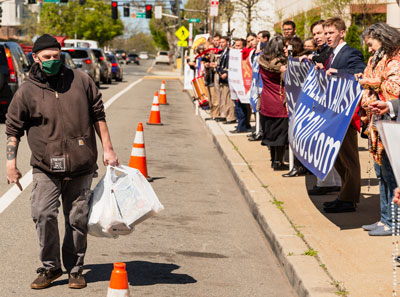 A man paced in front of the campaign, making devil horns and hailing the father of lies.